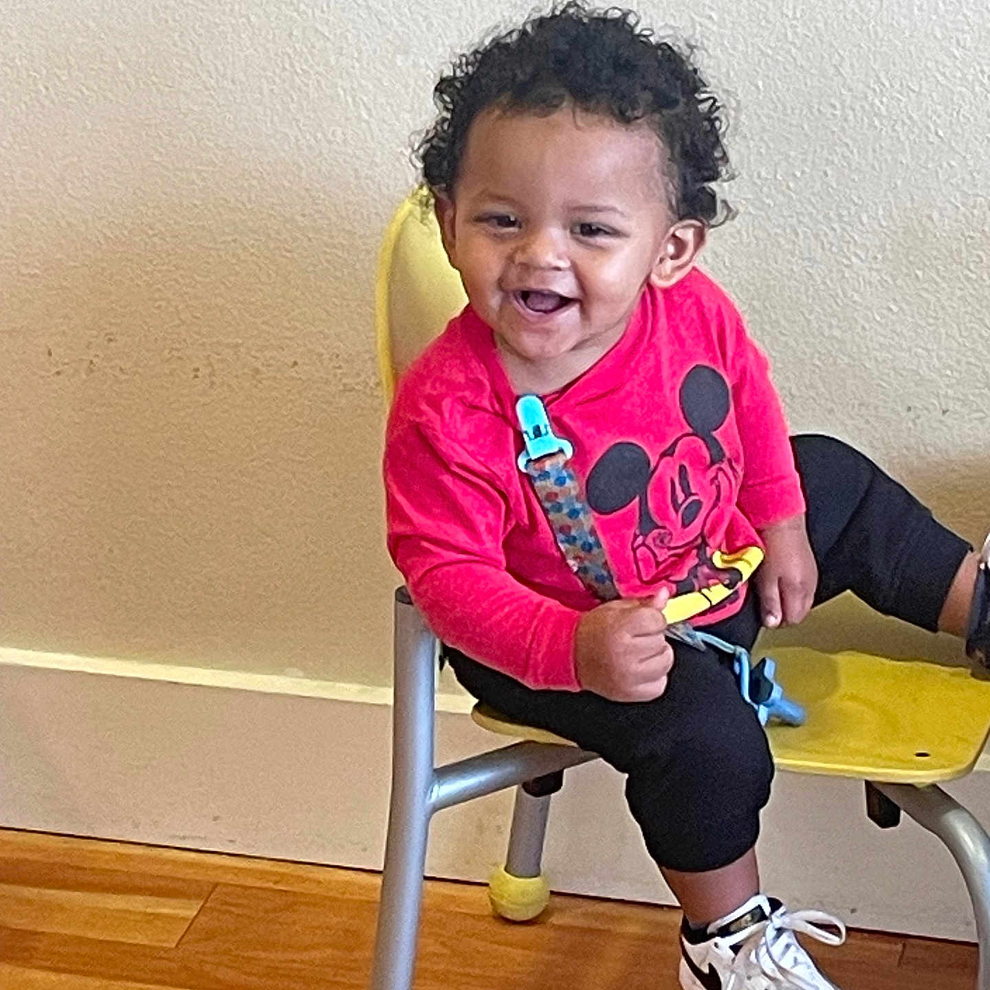 Kyrie is registered to the contest to win money with this photo: baby, babylaughing, blackhair, chair, clothing, curlyhair, face, footwear, furniture, hair, happy, head, indoors, interiordesign, person, photography, portrait, shoe, sitting, sneaker