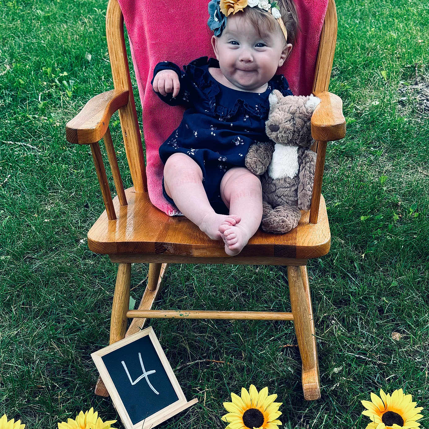 Katherine is registered to the contest to win money with this photo: baby, backyard, chair, face, flower, furniture, grass, head, herbal, nature, outdoors, park, person, petal, photography, plant, portrait, sitting, summer, yard