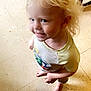 Axel joined the competition — help win amazing prizes! child, toddler, blonde_hair, barefoot, smiling, indoor, floor, tile_floor, table, wooden_table, curly_hair, happy, person, standing, casual_clothing, short_sleeve_shirt, cute, playful, young_child, light