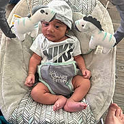 Micah Jackson joined the competition — help win amazing prizes! baby, infant, baby_seat, plush_toys, zebra_toys, hat, nike_shirt, footwear_absent, patterned_fabric, baby_clothing, baby_bouncer, flooring, foot, indoor, soft_toys, baby_face, baby_feet, baby_hands, baby_hat, baby_gaze