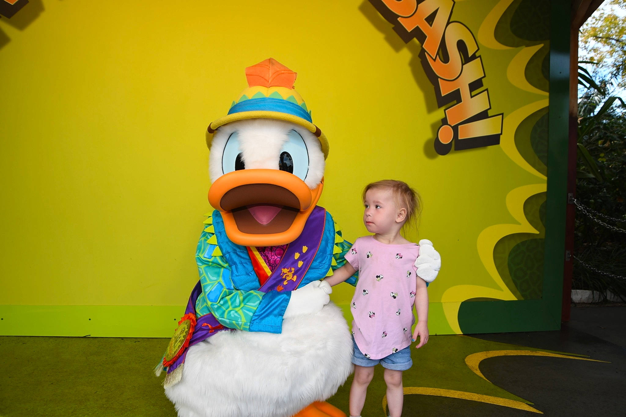 Olivia is registered to the contest to win money with this photo: animated_cartoon, animation, cartoon, child, event, fictional_character, fun, grass, happy, leisure, mascot, person, plant, recreation, room, toddler, toy, tree