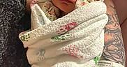 Arianna joined the competition — help win amazing prizes! baby, blanket, childbirth, face, head, newborn, person, photography, portrait, quilt, skin, sleeping, tattoo, towel