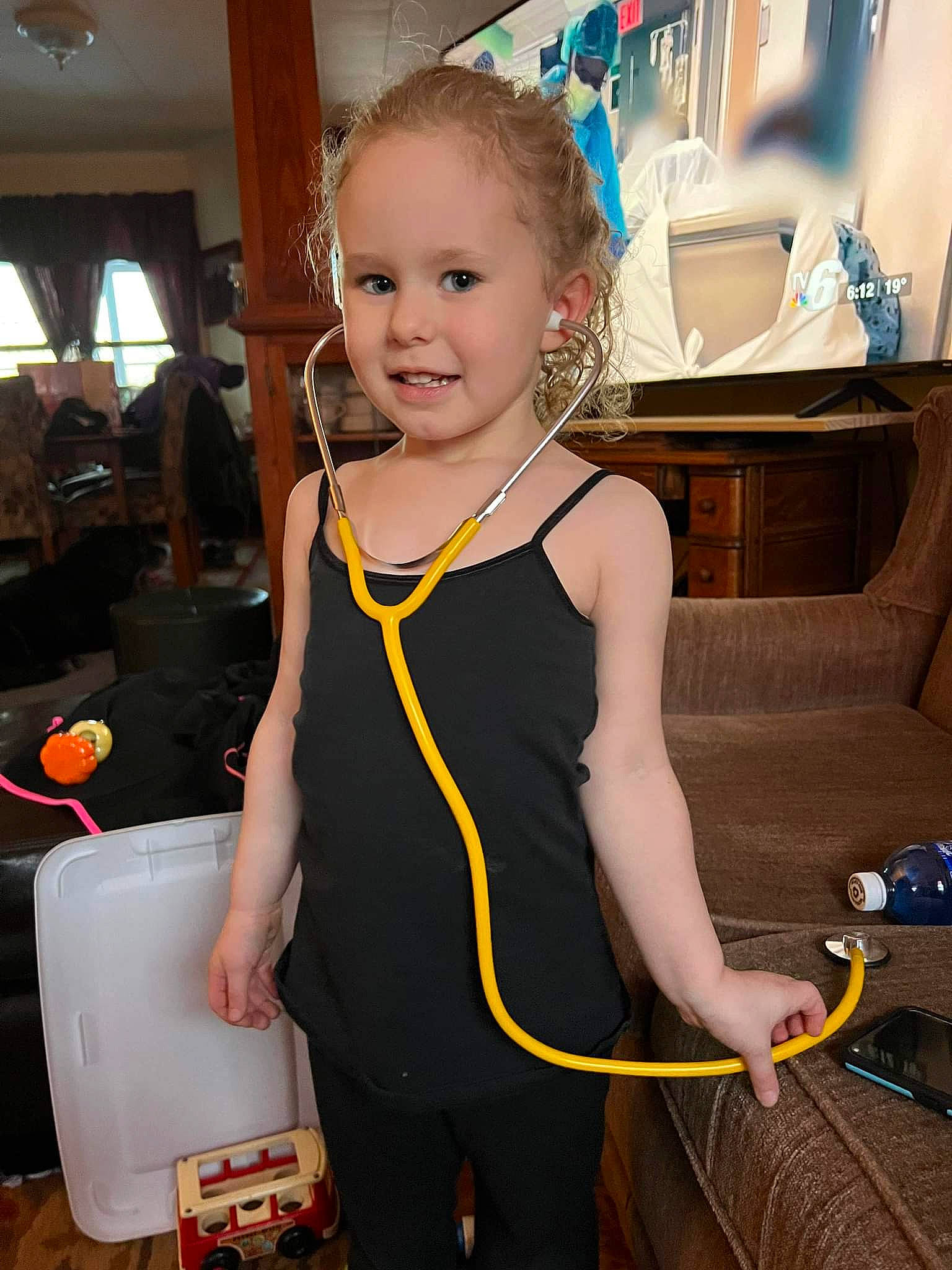 Nevaeh is registered to the contest to win money with this photo: baby_toddler_clothing, bag, child, event, finger, flooring, fun, hairstyle, happy, houseplant, joint, luggage_and_bags, person, shoulder, sleeve, sleeveless_shirt, smile, standing, t_shirt, toddler