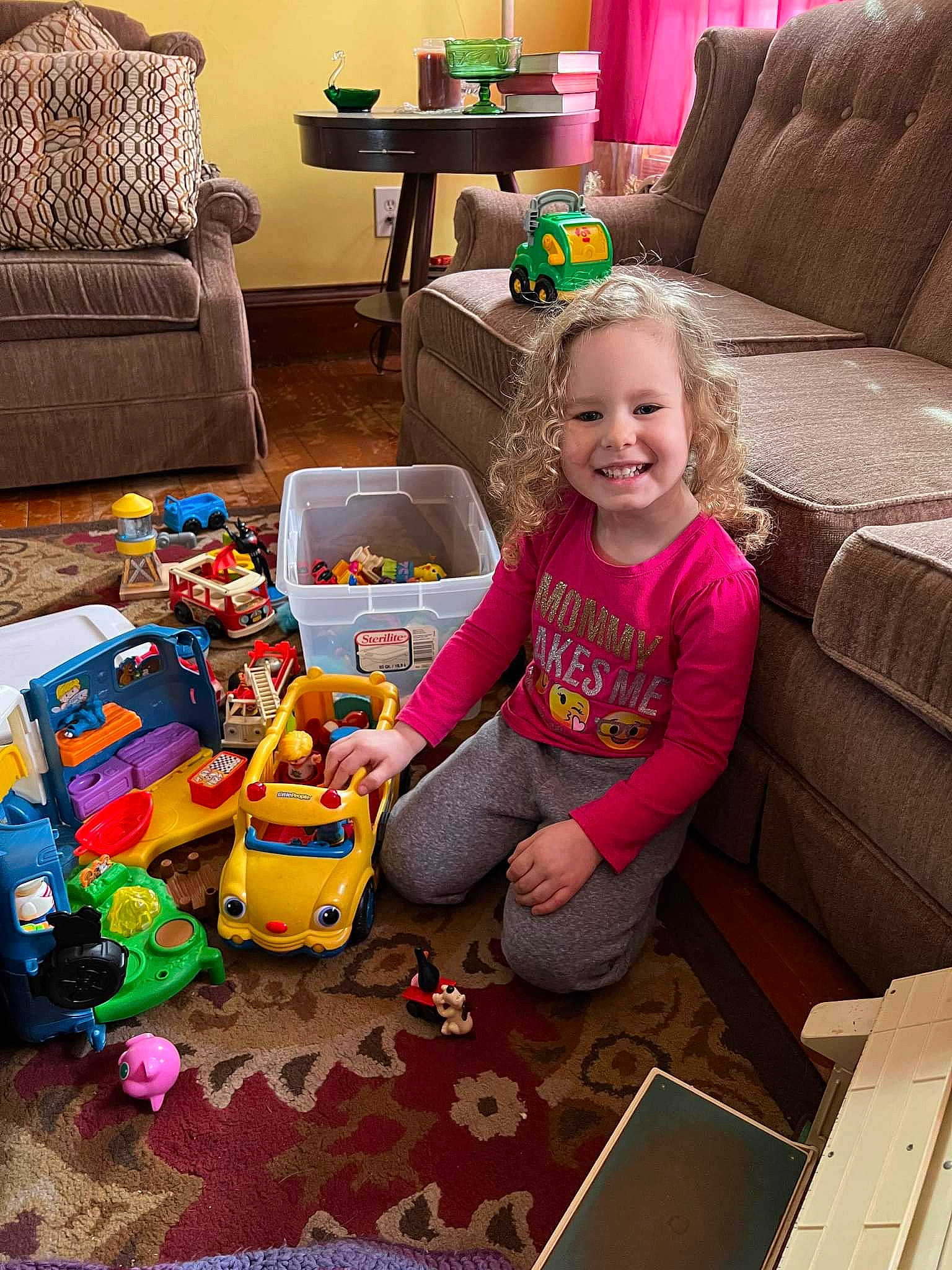 Nevaeh is registered to the contest to win money with this photo: child, comfort, couch, event, floor, flooring, fun, green, happy, joy, lap, leisure, living_room, person, product, room, sharing, sitting, smile, snapshot