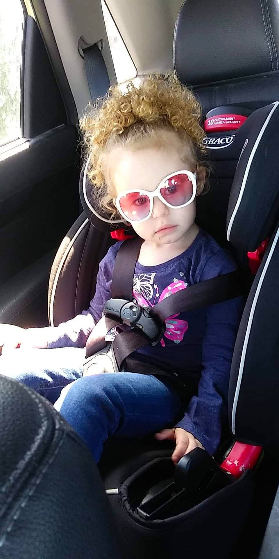 Nevaeh joined the competition — help win amazing prizes! automotive_design, car, car_seat, car_seat_cover, comfort, eyewear, face, glasses, goggles, head_restraint, jeans, mammal, motor_vehicle, person, seat_belt, steering_part, steering_wheel, sunglasses, toddler, vehicle_door