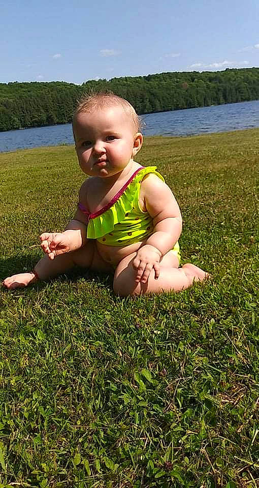 Olivia joined the competition — help win amazing prizes! baby, baby_toddler_clothing, fun, grass, grass_family, grassland, green, groundcover, happy, landscape, lawn, leisure, meadow, people_in_nature, person, plant, sitting, sky, thumb, toddler