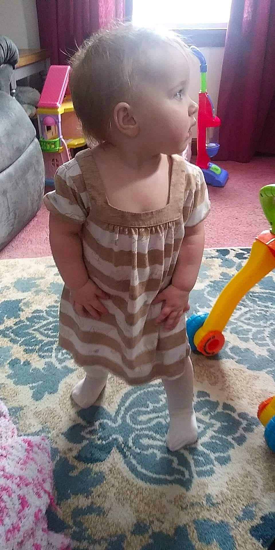 Olivia is registered to the contest to win money with this photo: baby, baby_toddler_clothing, child, floor, flooring, foot, fun, grass, green, human_leg, leisure, pattern, person, pink, play, sitting, skin, sleeve, toddler, toy