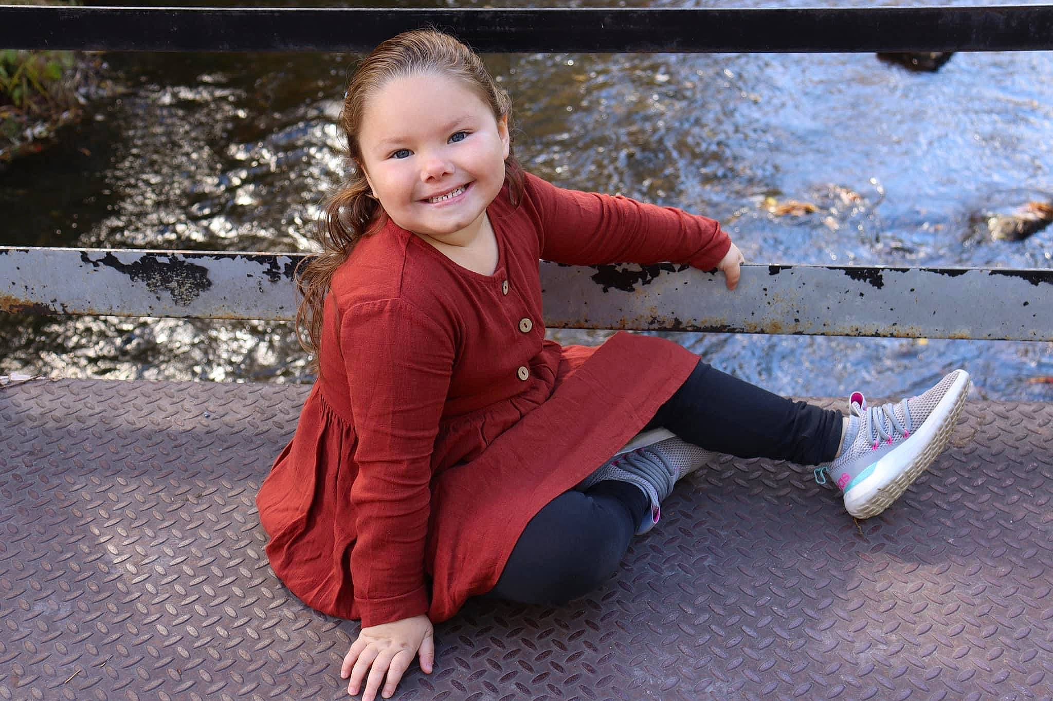 Ava joined the competition — help win amazing prizes! asphalt, baby_toddler_clothing, child, face, flooring, foot, fun, grass, happy, human_leg, joy, knee, leg, leisure, people_in_nature, person, road_surface, sitting, smile, toddler