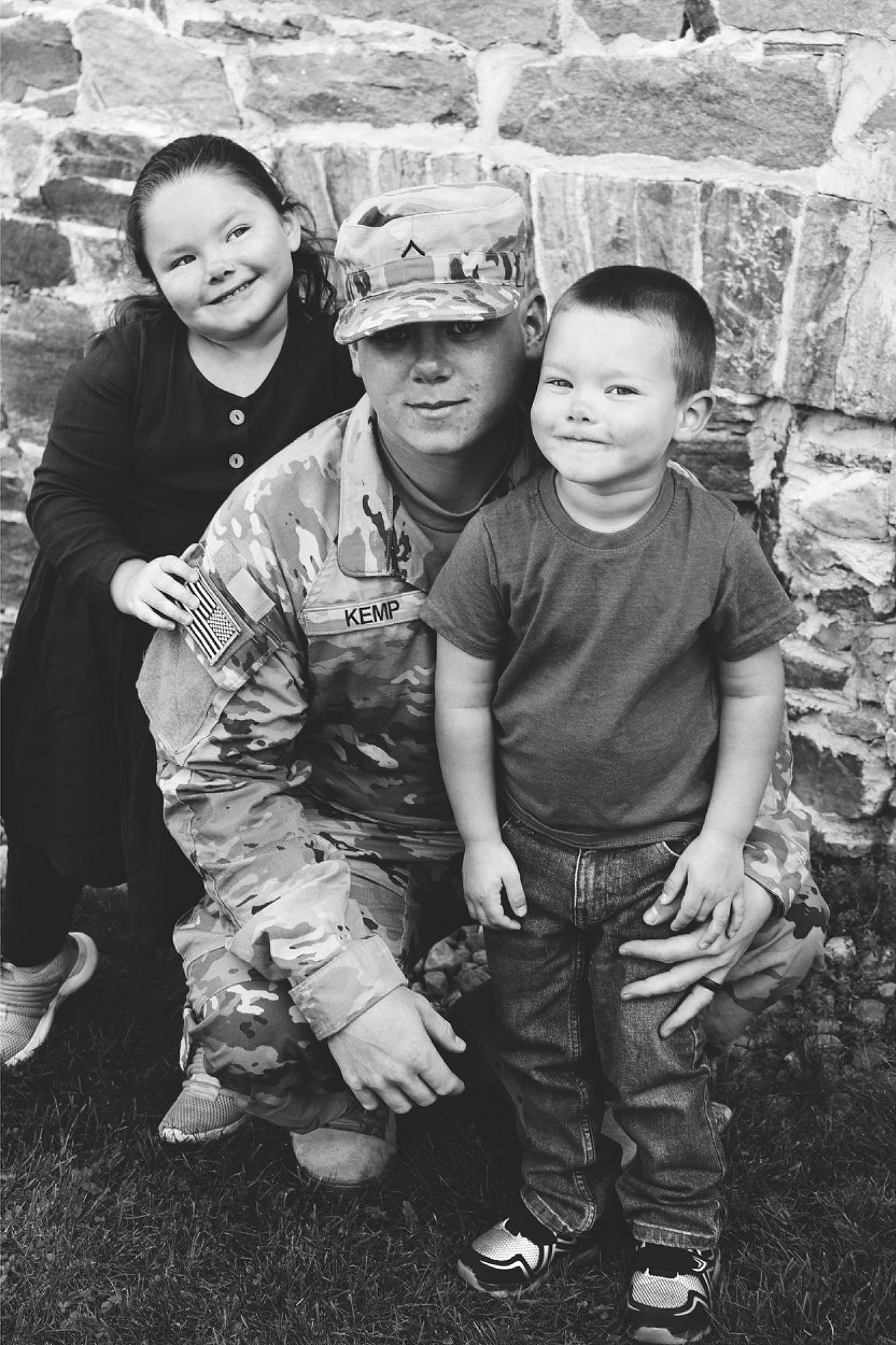 Konnor joined the competition — help win amazing prizes! black_and_white, footwear, fun, grass, happy, hat, headgear, headwear, joy, military_camouflage, military_person, military_uniform, monochrome, monochrome_photography, person, shoe, sitting, smile, sneakers, standing