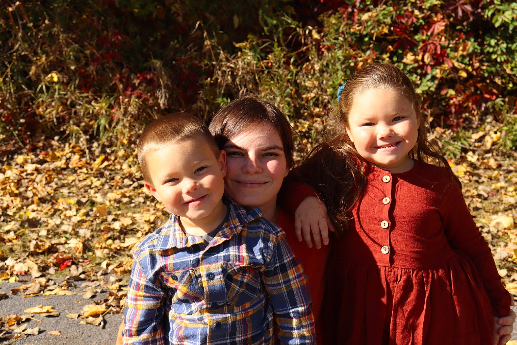 Konnor is registered to the contest to win money with this photo: child, event, fun, grass, happy, joy, leaf, leisure, orange, people_in_nature, person, plaid, red, shirt, smile, soil, standing, t_shirt, tartan, toddler