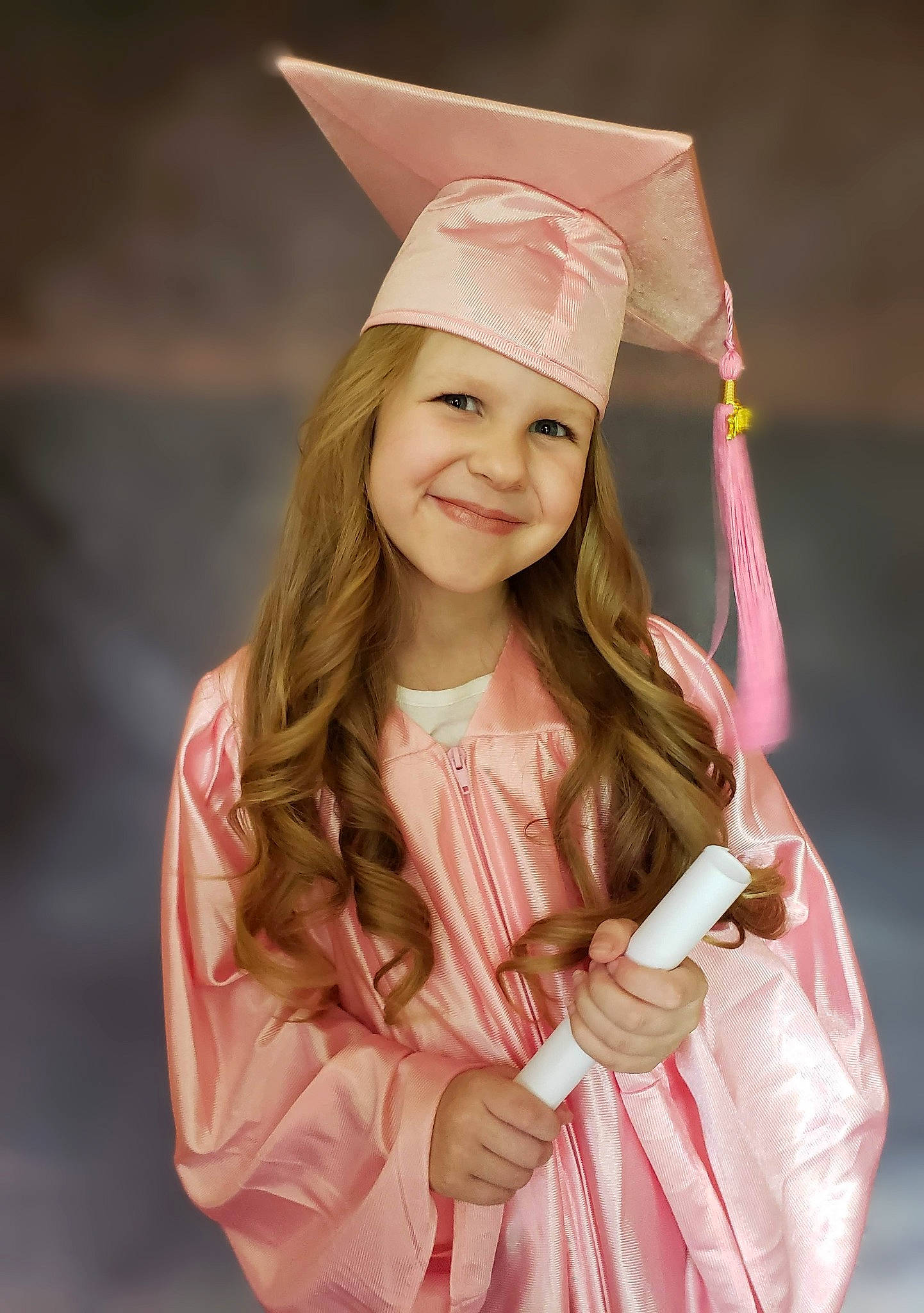 Justice is registered to the contest to win money with this photo: academic_dress, blond, child, costume, dress, event, fashion_design, fun, gesture, happy, headgear, headwear, jewellery, joy, mortarboard, person, pink, scholar, skin, smile