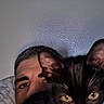Bats is registered to the contest to win money with this photo: animal, black_and_white_cat, cat, close_up, cozy, curious, eyes, face, fur, head, human, indoor, looking, man, person, pet, portrait, resting, wall, whiskers