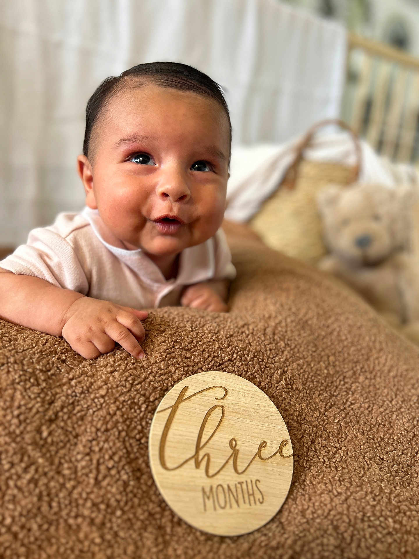 Isaiah is registered to the contest to win money with this photo: baby, infant, three_months, blanket, brown, face, expression, teddy_bear, basket, soft_focus, indoor, child, cute, portrait, skin, person, clothing, happy, smile, young