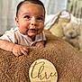 Isaiah is registered to the contest to win money with this photo: baby, infant, three_months, blanket, brown, face, expression, teddy_bear, basket, soft_focus, indoor, child, cute, portrait, skin, person, clothing, happy, smile, young