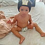 Weston is registered to the contest to win money with this photo: toddler, child, beanie, hat, bed, diaper, room, window, curtain, blanket, bag, floor, slipper, indoor, furniture, person, sitting, expression, curious, messy