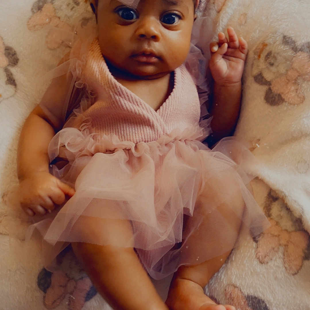 Milahni joined the competition — help win amazing prizes! adorable, baby, blanket, cartoon_characters, child, clothing, cute, fabric, feet, hands, headband, indoor, infant, person, pink_tutu, portrait, sitting, soft_texture, wide_eyes, young_child