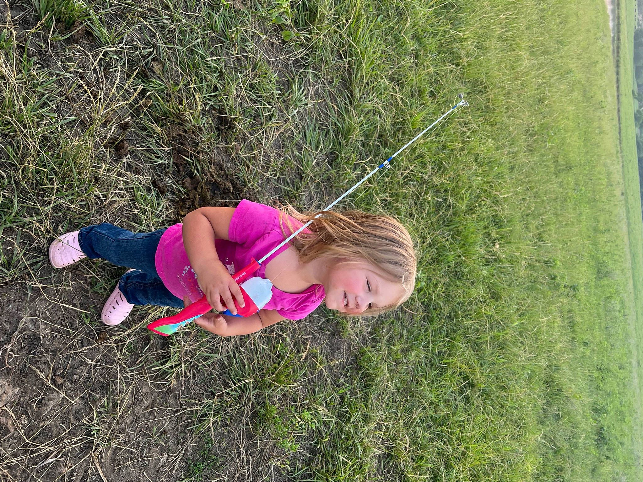 Athena is registered to the contest to win money with this photo: adventure, child, fun, grass, grass_family, grassland, happy, joy, landscape, lawn, leisure, pasture, people_in_nature, person, plant, play, prairie, recreation, shrub, soil
