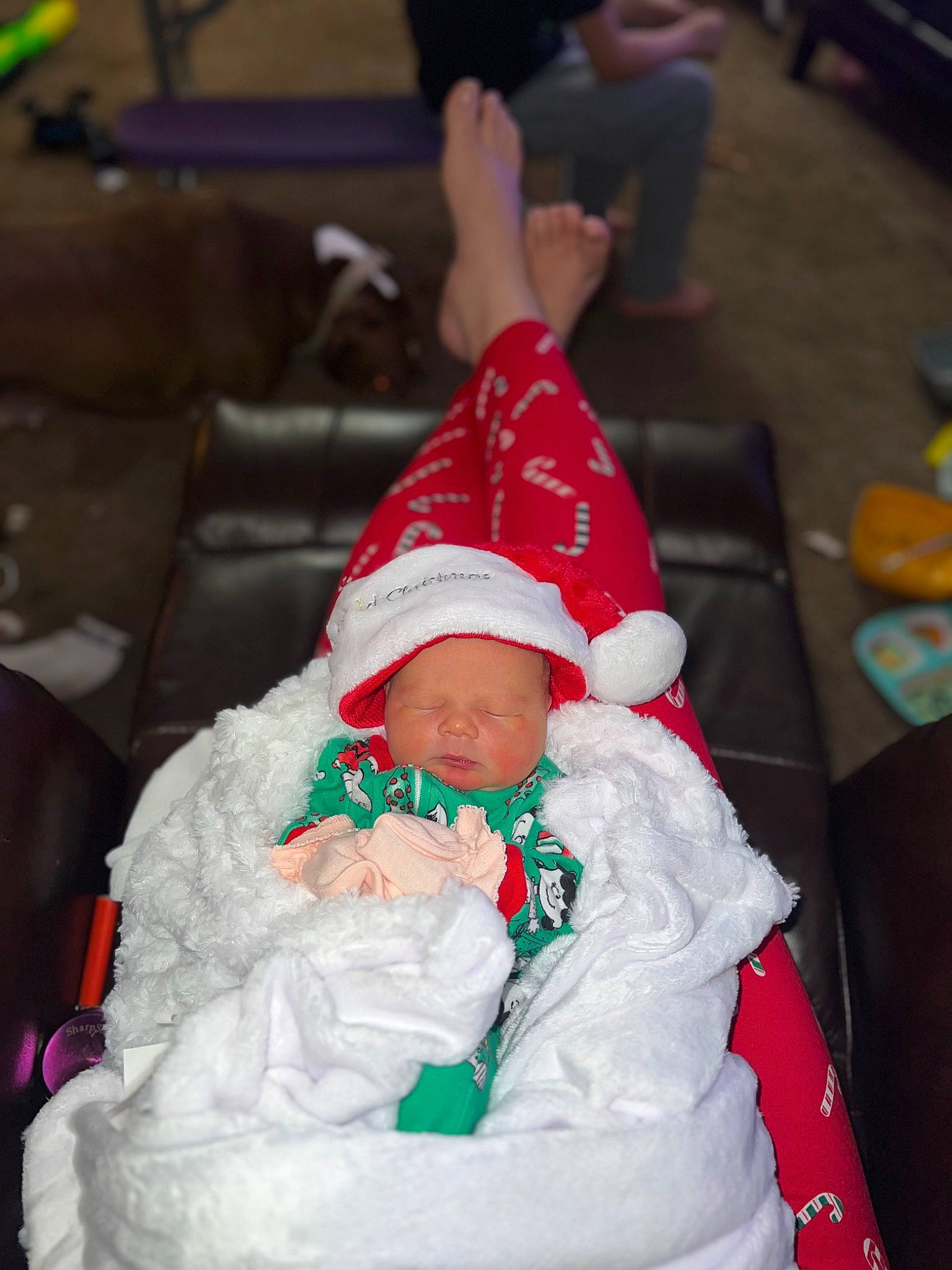Rowen joined the competition — help win amazing prizes! baby, carmine, chair, child, christmas, christmas_eve, costume, event, fictional_character, fun, hat, headgear, headwear, holiday, lap, person, plant, santa_claus, shorts, toddler