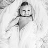 Cesar participe au concours pour gagner de l'argent avec cette photo : baby, infant, portrait, black_and_white, fabric, blanket, smile, cute, child, soft_texture, closeup, wrapped, lying_down, face, skin, newborn, expression, tulle, happy, charming
