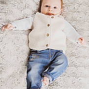Cesar participe au concours pour gagner de l'argent avec cette photo : baby, child, infant, lying_down, white_vest, blue_jeans, barefoot, fluffy_blanket, texture, cute, portrait, smiling, cozy, indoors, small_hands, small_feet, casual_clothing, happy, young, person