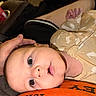 animal_print, baby, can, casual, close_up, comfort, couch, curious, expression, face, hand, indoor, infant, onesie, orange, person, resting, skin, soda, toy