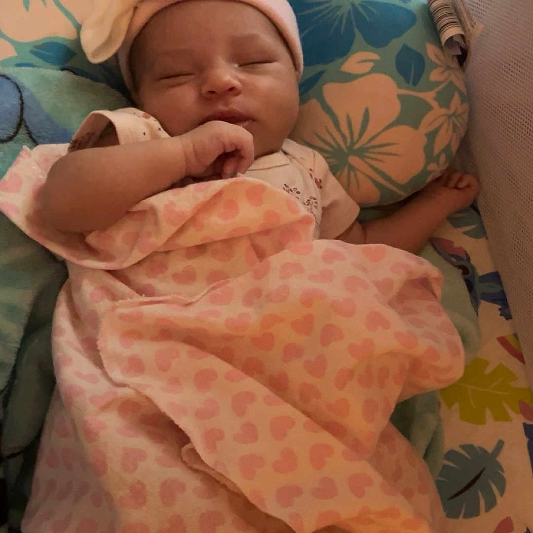 Taleah is registered to the contest to win money with this photo: baby, bedding, blanket, bow, cartoon, child, colorful, comfort, crib, cute, floral, hat, heart, infant, mesh, pattern, peaceful, pink, rest, sleeping