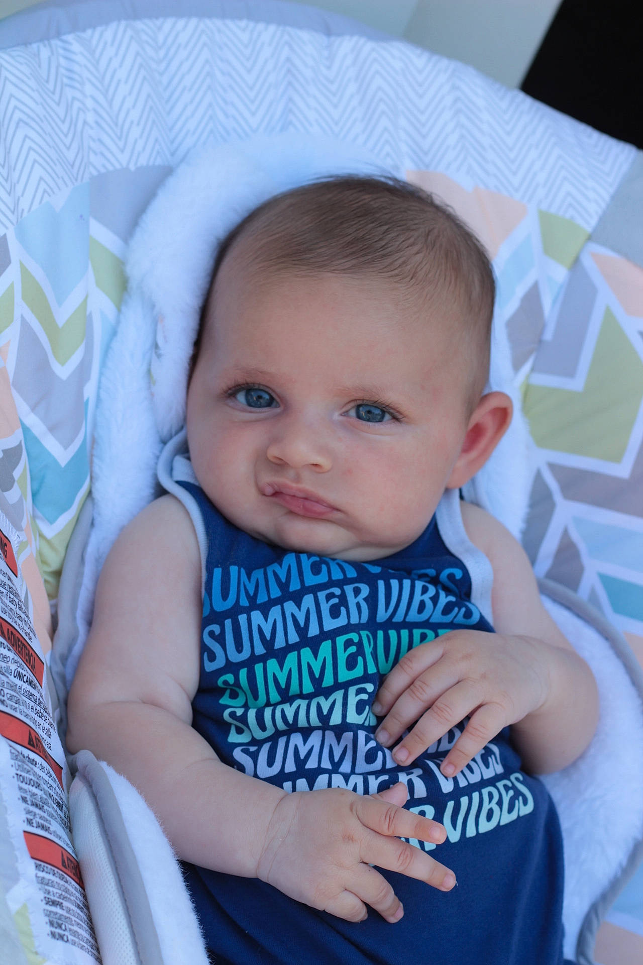 Ezra joined the competition — help win amazing prizes! arm, baby, baby_products, baby_toddler_clothing, cheek, child, comfort, electric_blue, eye, finger, fun, hairstyle, hand, happy, iris, nail, pattern, person, sitting, skin