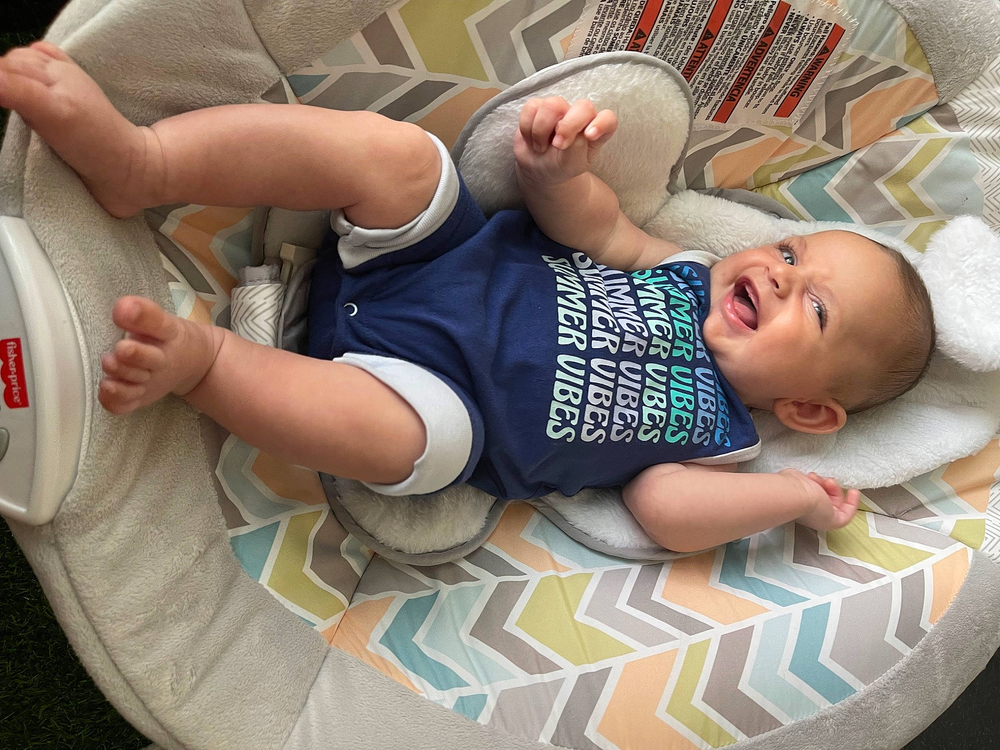 Ezra is registered to the contest to win money with this photo: arm, baby, baby_products, baby_safety, baby_sleeping, baby_toddler_clothing, child, comfort, elbow, happy, infant_bodysuit, pattern, person, product, sitting, sleeve, smile, t_shirt, thigh, toddler
