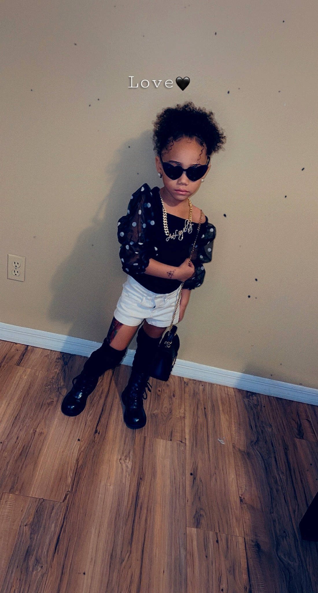 Aaloyalty is registered to the contest to win money with this photo: black_hair, eyewear, face, fashion_design, floor, flooring, footwear, glasses, goggles, hardwood, head, knee, person, sleeve, standing, street_fashion, sunglasses, t_shirt, thigh, vision_care