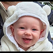 Matthew is registered to the contest to win money with this photo: baby, smiling, hood, white, fluffy, cute, child, face, portrait, outdoor, happy, apparel, warm_clothing, person, headwear, closeup, infant, joyful, baby_clothes, soft_texture