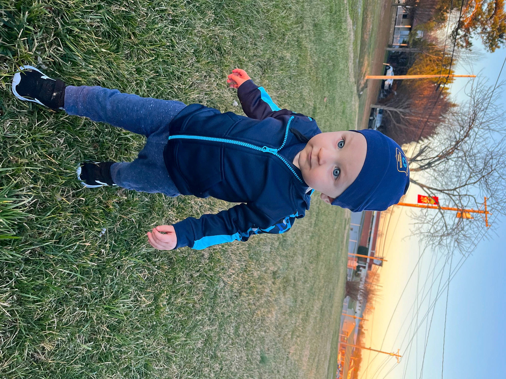 Connor is registered to the contest to win money with this photo: child, electric_blue, fun, grass, happy, hat, headwear, lake, leisure, people_in_nature, person, plant, recreation, sky, toddler, tree, twig, water, winter, wire