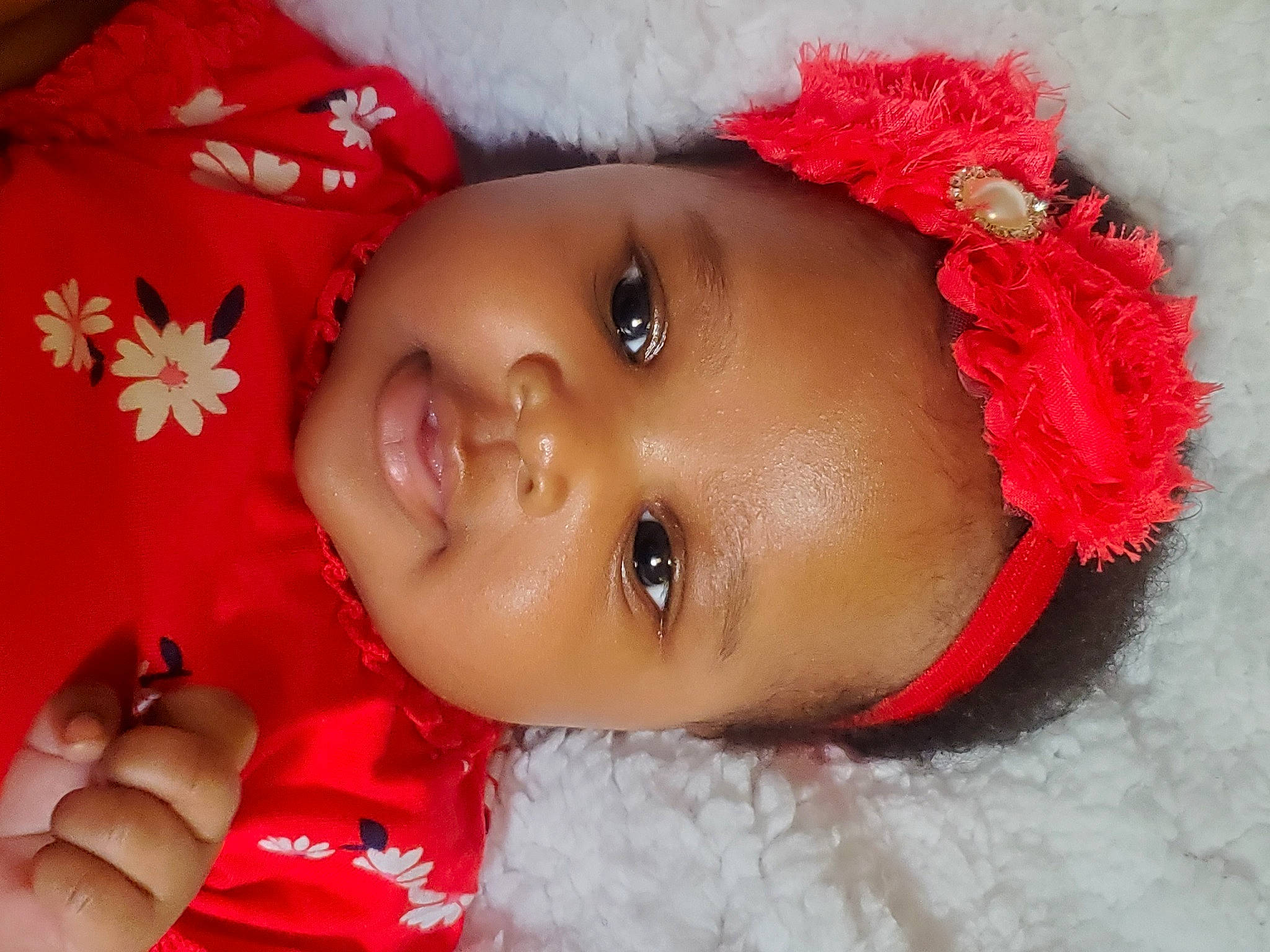 Danica is registered to the contest to win money with this photo: baby, cheek, child, close_up, eye, face, forehead, hair_accessory, head, headgear, headwear, lip, mouth, nose, person, red, skin, smile, toddler