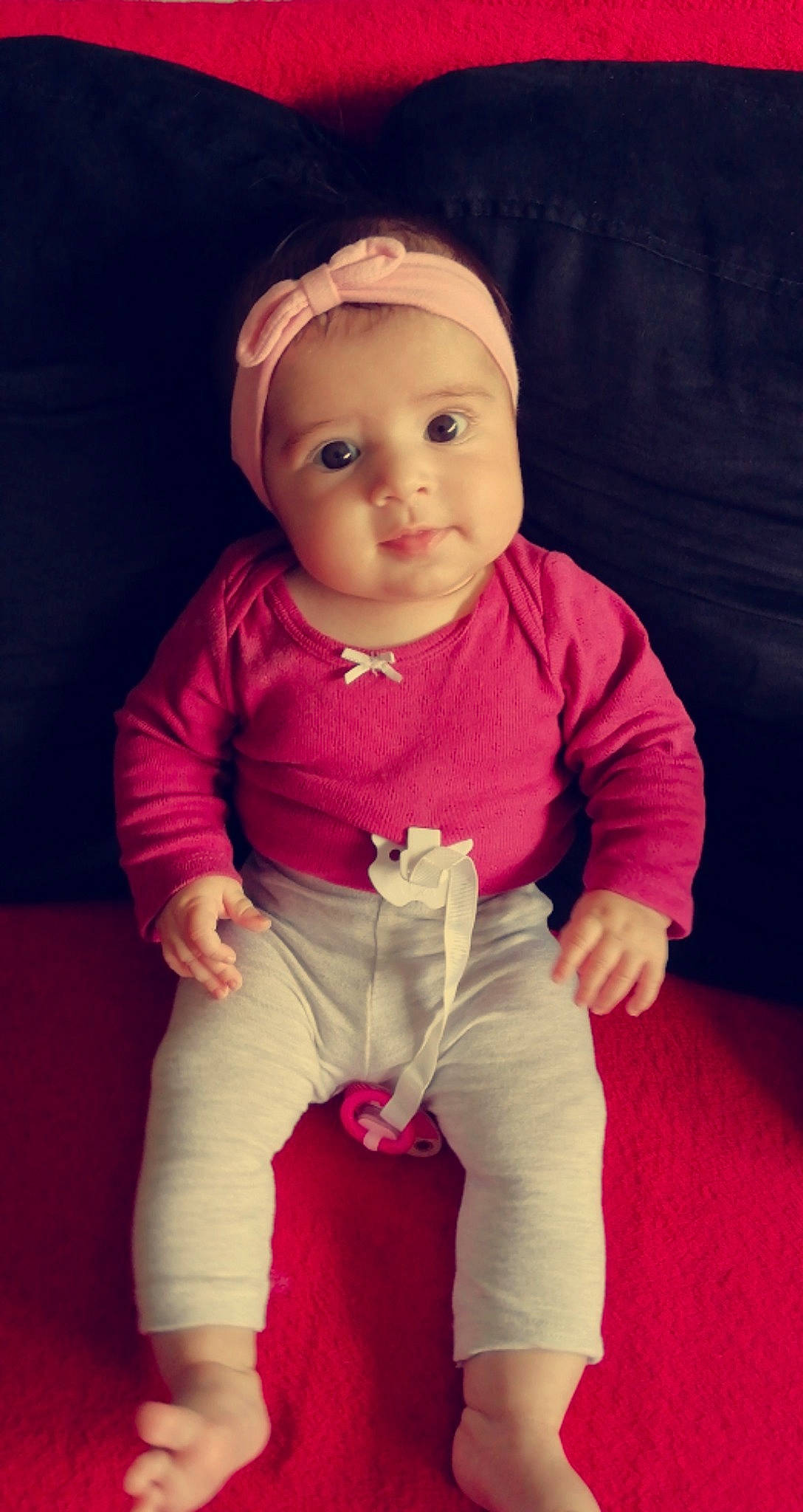 Leona participe au concours pour gagner de l'argent avec cette photo : baby, baby_toddler_clothing, cheek, child, face, flooring, happy, headwear, knee, lip, magenta, neck, nose, person, pink, purple, skin, sleeve, t_shirt, thigh