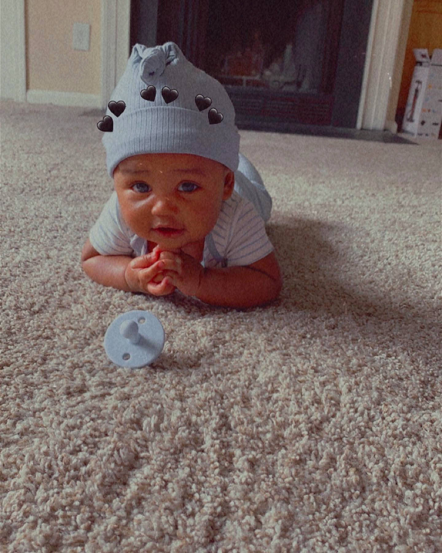 Davion is registered to the contest to win money with this photo: baby, baby_toddler_clothing, cap, carpet, child, comfort, crawling, door, floor, flooring, fun, grass, hardwood, headwear, person, room, sitting, skin, sleeve, toddler