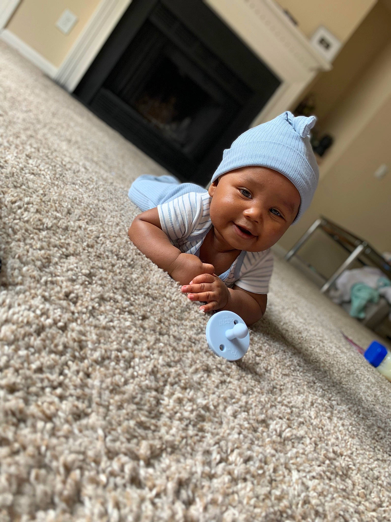 Davion is registered to the contest to win money with this photo: asphalt, baby, ball, cap, child, floor, flooring, fun, grass, happy, headwear, leisure, people_in_nature, person, play, recreation, road_surface, sand, sitting, soil