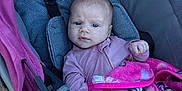 Finleigh joined the competition — help win amazing prizes! baby, blanket, blue_eyes, bundle, child, clothing, expression, fabric, face, furrowed_brow, hand, head, infant, outdoor, person, pink, seat, straps, stroller, young_child