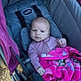 Finleigh joined the competition — help win amazing prizes! baby, stroller, blanket, pink, child, infant, clothing, face, person, outdoor, seat, straps, furrowed_brow, fabric, bundle, young_child, expression, hand, head, blue_eyes