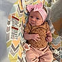 Finleigh is registered to the contest to win money with this photo: baby, infant, headband, pink, bow, pacifier, baby_seat, clothing, patterned, leopard_print, pink_pants, infant_girl, face, hands, straps, warning_label, indoor, comfort, cute, resting
