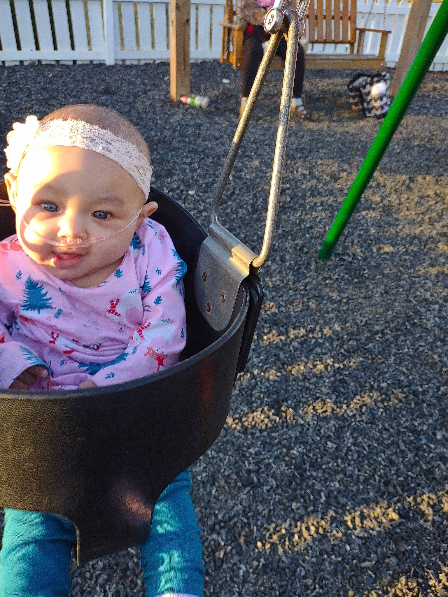 Carlyana is registered to the contest to win money with this photo: baby, baby_products, baby_toddler_clothing, child, city, electric_blue, face, fun, grass, happy, headwear, leisure, outdoor_furniture, outdoor_play_equipment, person, play, recreation, sitting, smile, swing