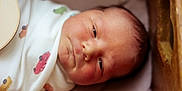 Grayson is registered to the contest to win money with this photo: newborn, baby, infant, blanket, crib, face, sleeping, closeup, swaddled, child, skin, peaceful, soft_lighting, indoors, cute, portrait, resting, head, young, baby_clothes