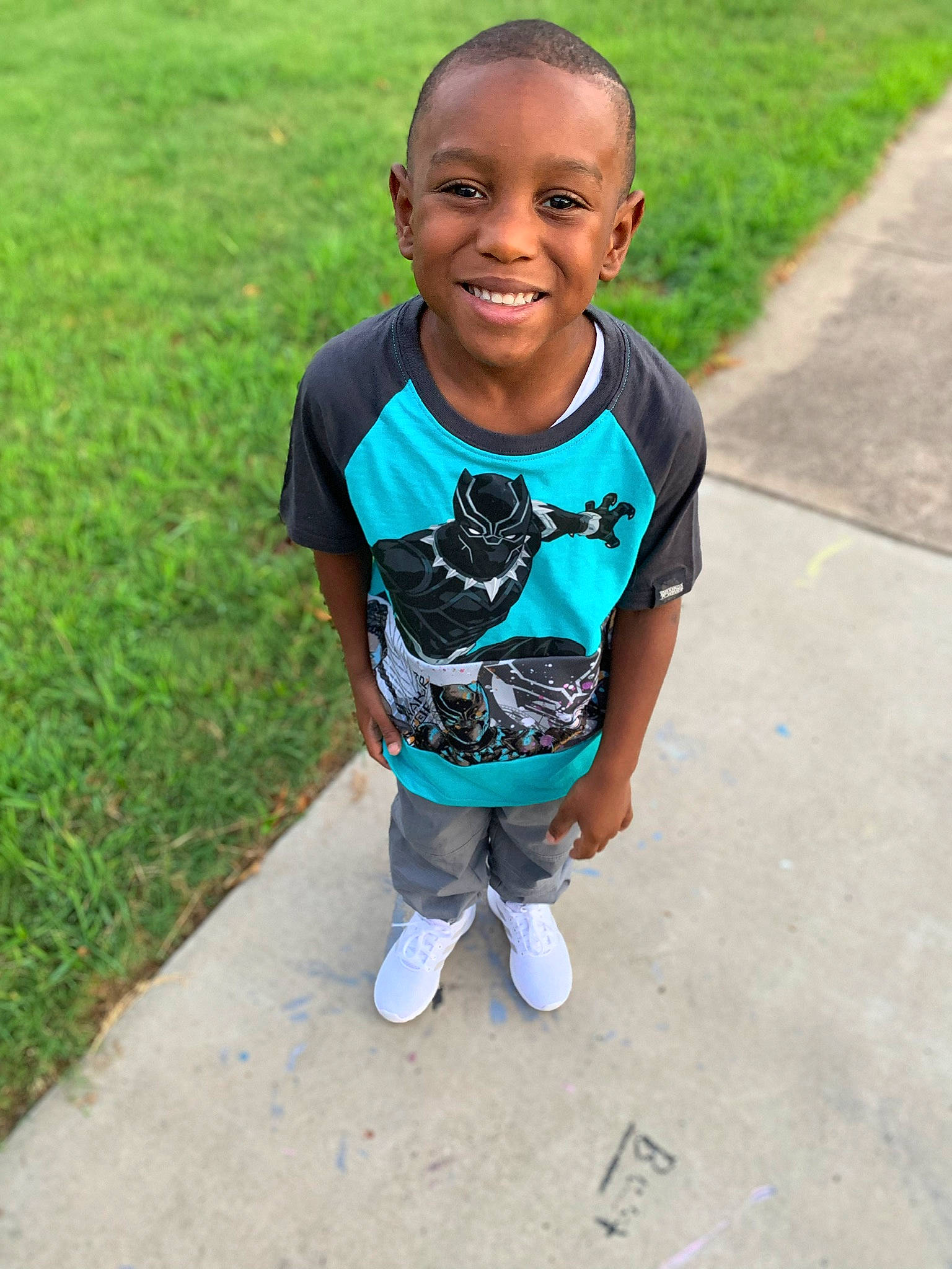 Keilin Holden is registered to the contest to win money with this photo: baby, blue, child, face, facial_expression, grass, green, happy, head, joy, person, plant, play, recreation, smile, summer, t_shirt, toddler, vacation