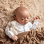 baby, blanket, bodypart, couch, face, finger, furniture, hand, happy, head, homedecor, newborn, person, photography, portrait, quilt, sitting, sleeping, smile, wool