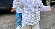 Stefania is registered to the contest to win money with this photo: toddler, child, baby, outdoor, street, clothing, hat, sweater, pants, shoes, curious, walking, person, urban, daylight, car, background, focus, portrait, cute