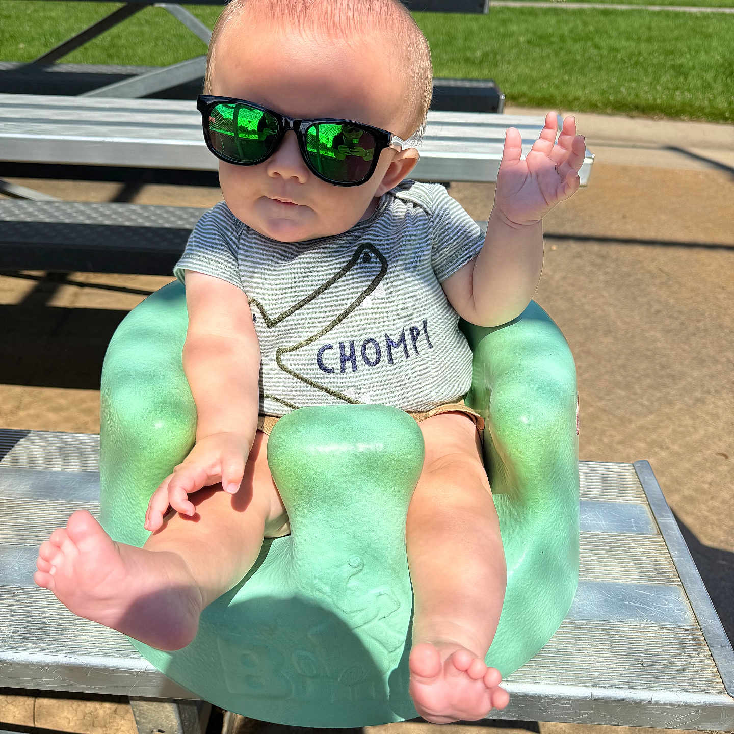 Owen is registered to the contest to win money with this photo: accessories, baby, bench, bodypart, face, finger, furniture, glasses, grass, hand, head, nature, outdoors, park, person, photography, plant, portrait, summer, sunglasses