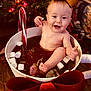 Tinsley joined the competition — help win amazing prizes! baby, child, smiling, bow, marshmallows, candy_cane, cup, holiday, christmas_tree, festive, indoors, wooden_floor, thumbs_up, cheerful, cute, holiday_decor, warm_lighting, celebration, portrait, holiday_season