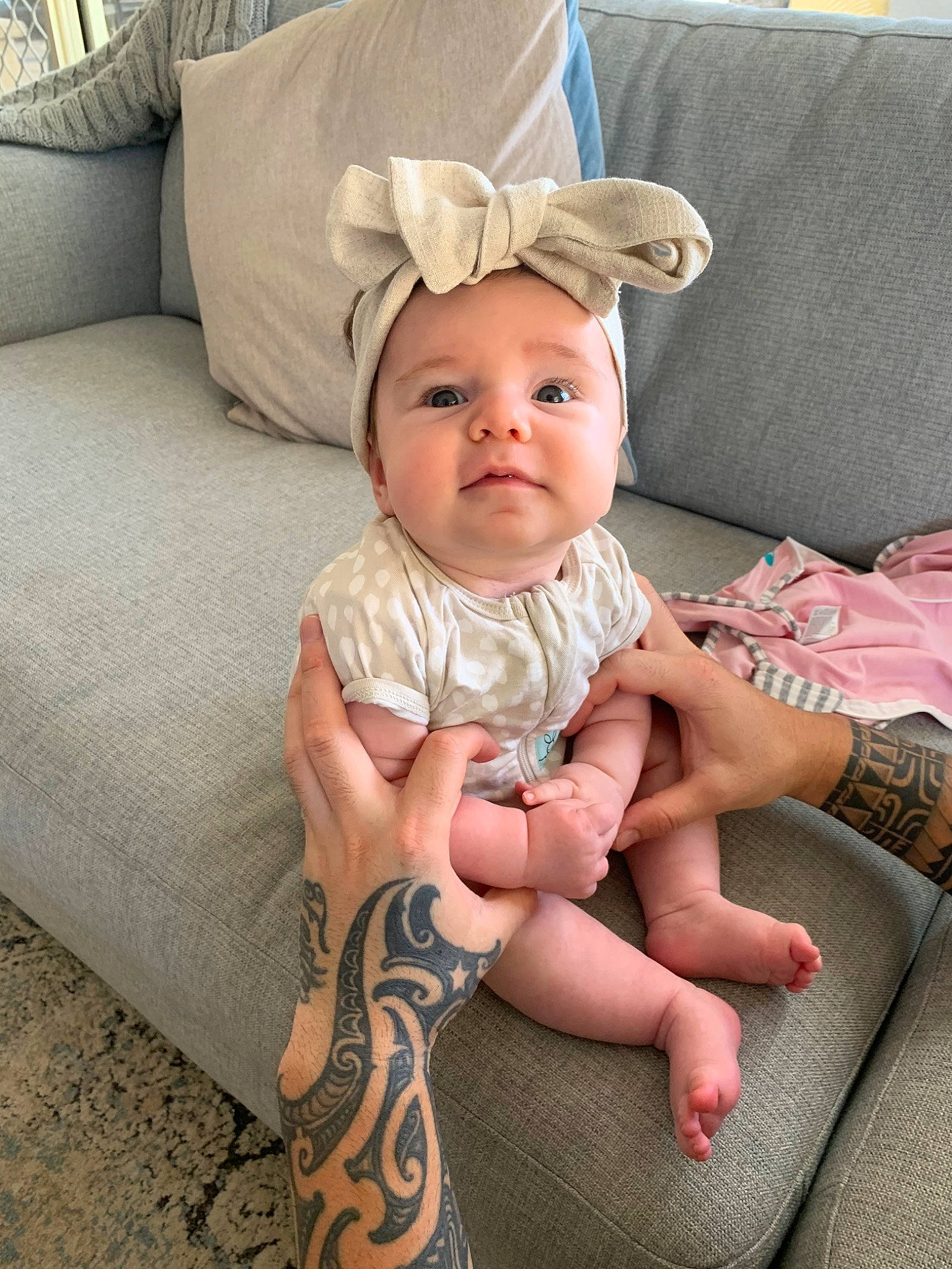 Capri joined the competition — help win amazing prizes! arm, baby, baby_toddler_clothing, blond, child, fashion_accessory, footwear, hand, hat, head, headgear, joint, leg, person, pink, sitting, skin, sleeve, smile, thigh