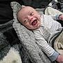 Mason is registered to the contest to win money with this photo: baby, infant, smiling, happy, blanket, cozy, clothing, striped, lying_down, face, child, cute, soft_texture, warm, indoor, newborn, joy, expression, skin, sleepwear
