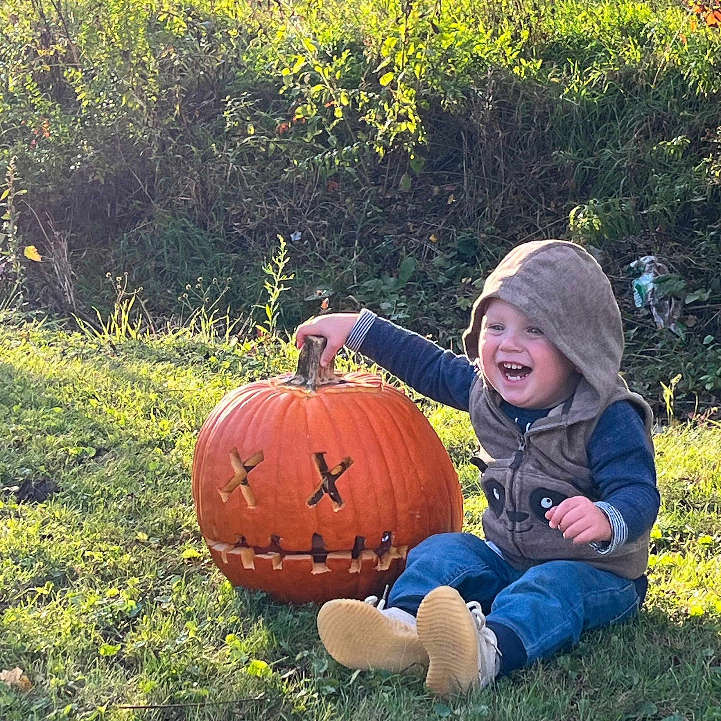 Oliver is registered to the contest to win money with this photo: boy, child, clothing, face, food, grass, head, male, nature, outdoors, pants, park, person, photography, plant, portrait, produce, squash, vegetable, vegetation