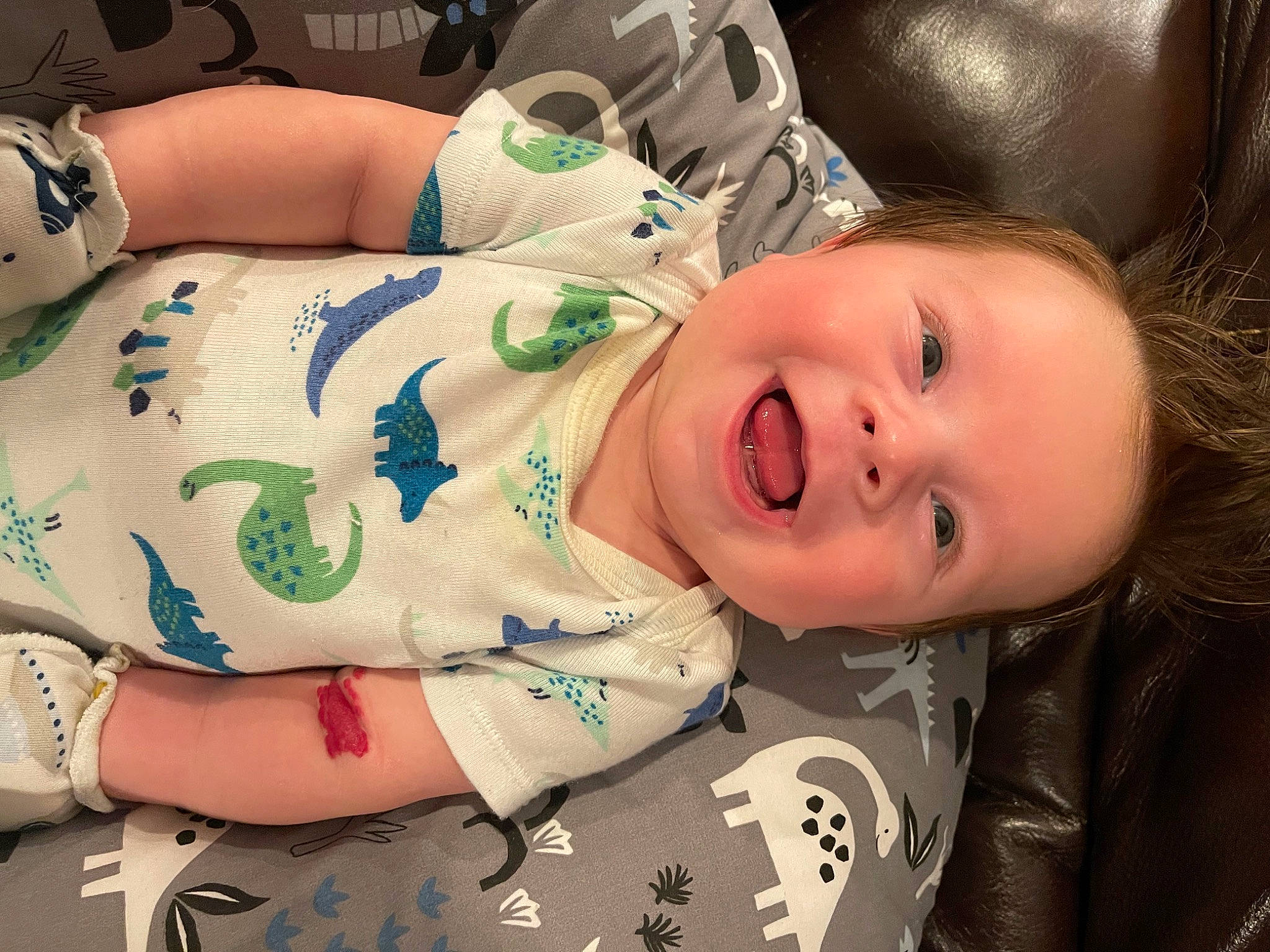 Maddox is registered to the contest to win money with this photo: abdomen, baby, baby_laughing, baby_toddler_clothing, cheek, chest, child, comfort, face, hairstyle, happy, head, joy, lip, mouth, nose, person, sitting, skin, sleeve
