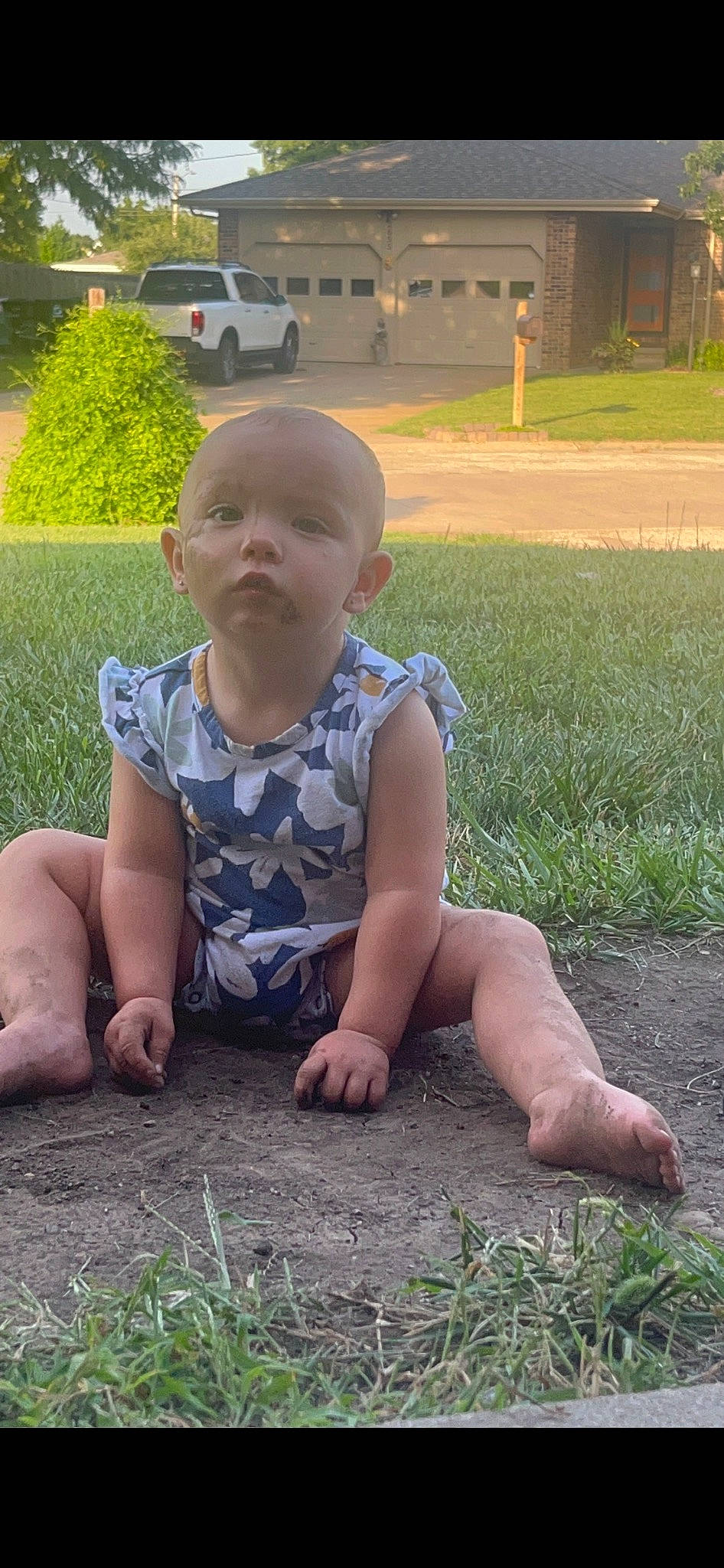 Josephine is registered to the contest to win money with this photo: baby, baby_toddler_clothing, botany, child, face, facial_expression, fun, grass, grass_family, groundcover, hairstyle, head, human_body, lawn, people_in_nature, person, plant, sitting, standing, summer
